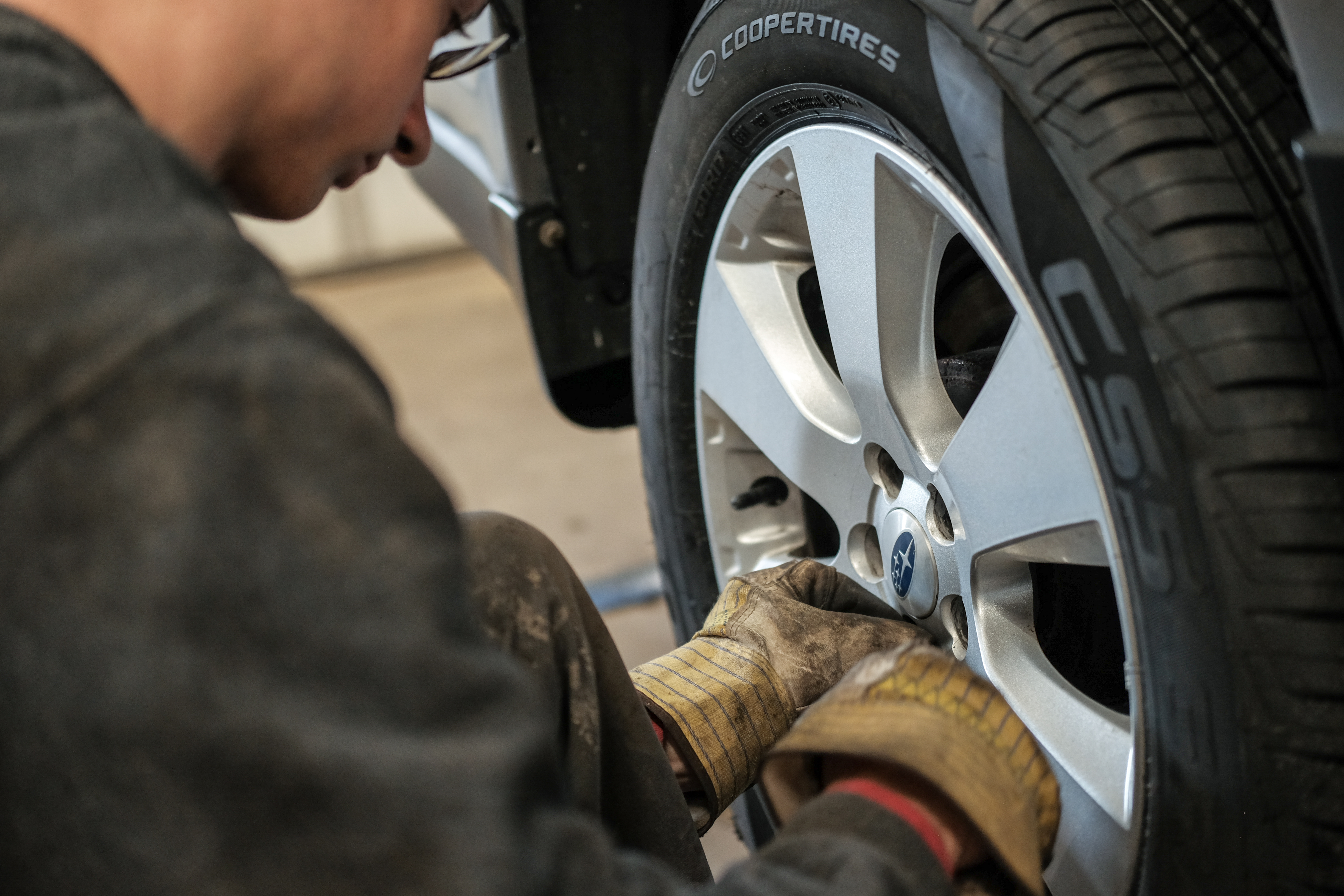 Trained tire technician at Wonderland Tire finishing up a tire replacement.