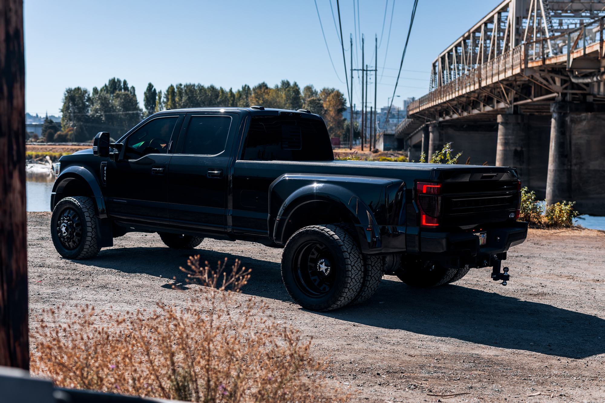 A black truck with dually tires 